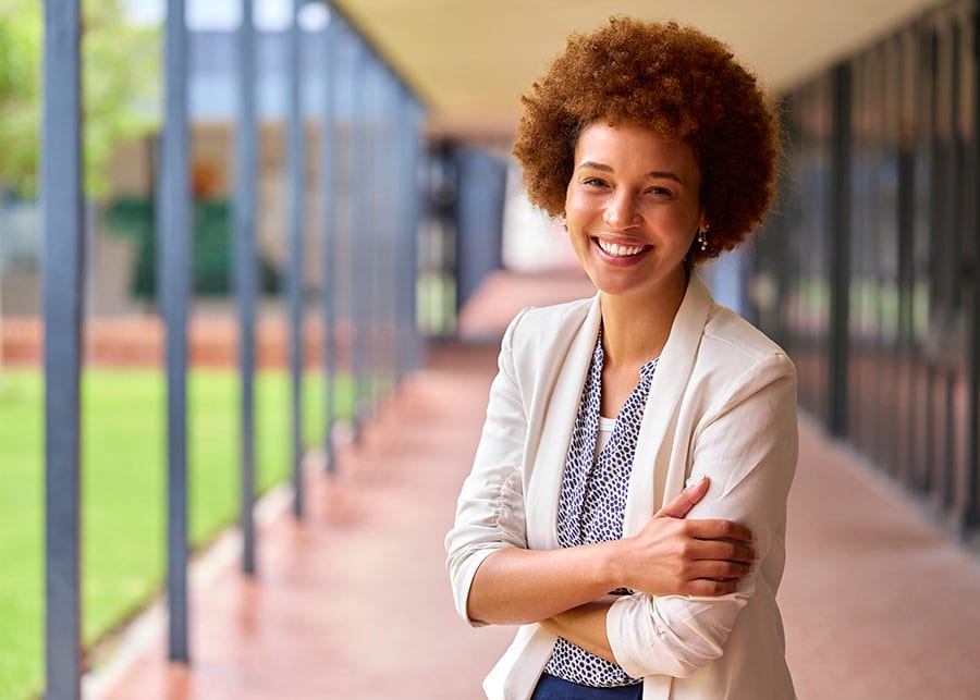 Confident woman standing outside of a school building