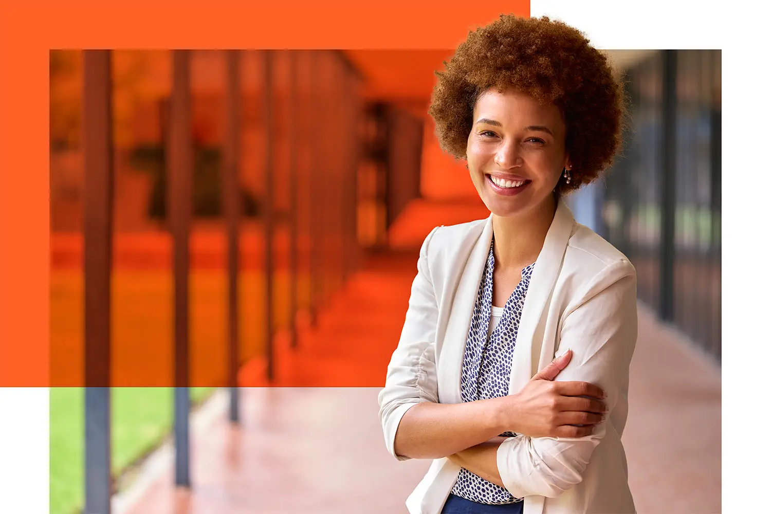 Confident teacher smiling in front of a school